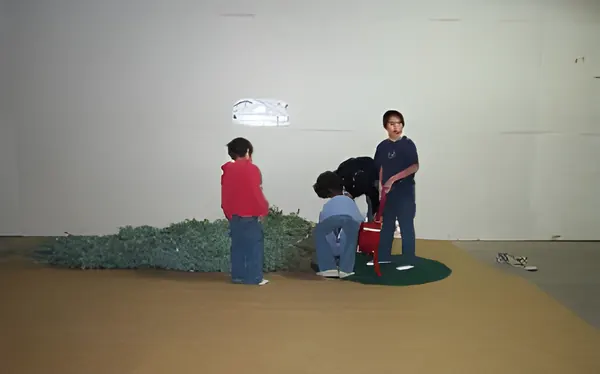 Children setting up a tree in the stand, step 1