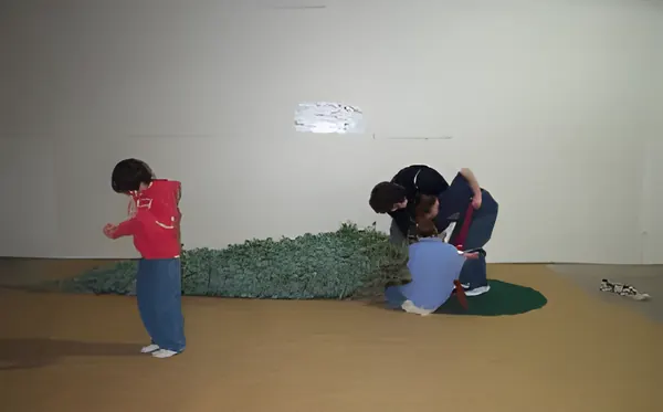 Children setting up a tree in the stand, step 2
